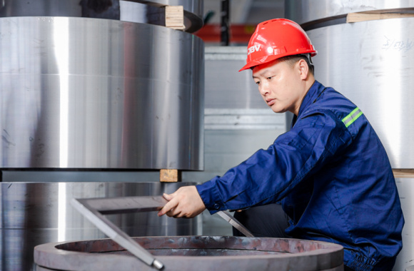 dombor's worker checking the valve component