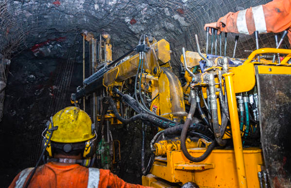 Mining operator on mining machine underground mine mesh